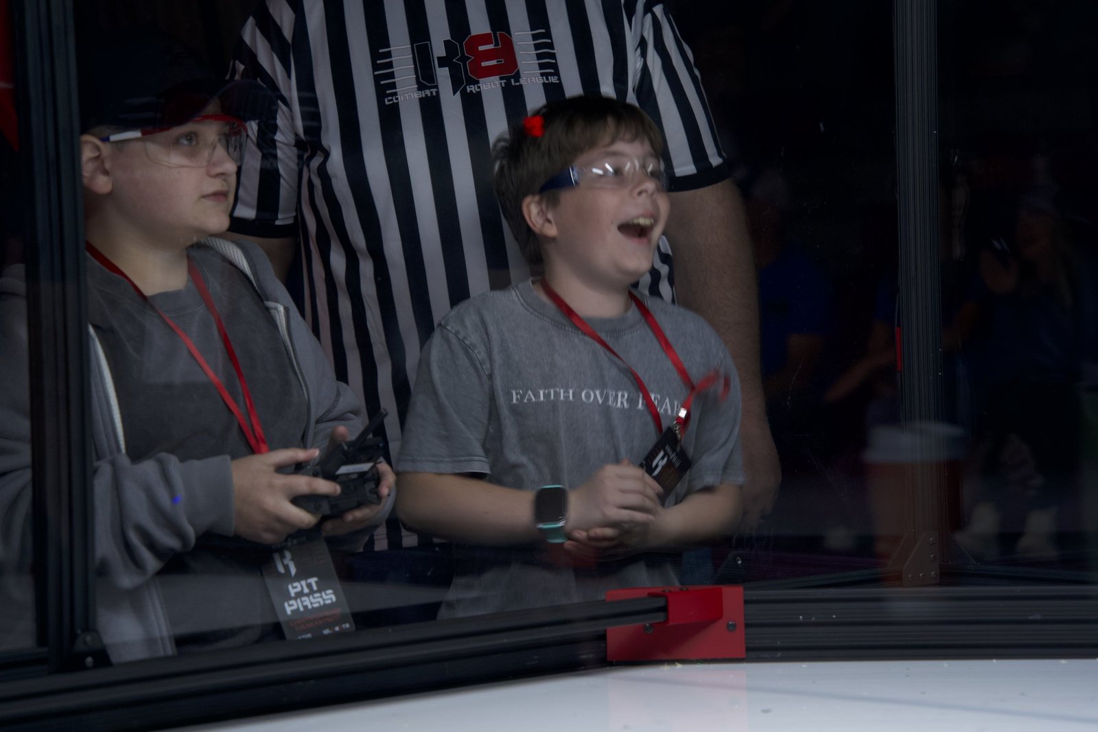Two students driving their Kilobots robot